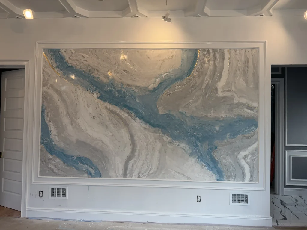Custom decorative Venetian plaster wall finish with blue and grey marbled texture and gold highlights.
